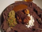 Cooking Ethiopian Doro Wot in a Shalka Dist, a Traditional Ethiopian Clay Pot