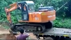 Only in India...How not to unload an excavator